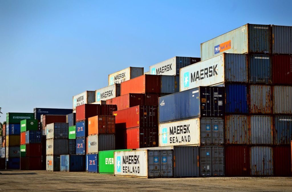 pexels-photo-906494 Colorful stacked shipping containers at a port exemplify global logistics.