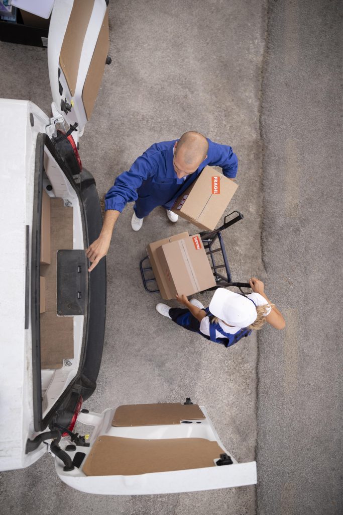 full-shot-delivery-people-holding-box