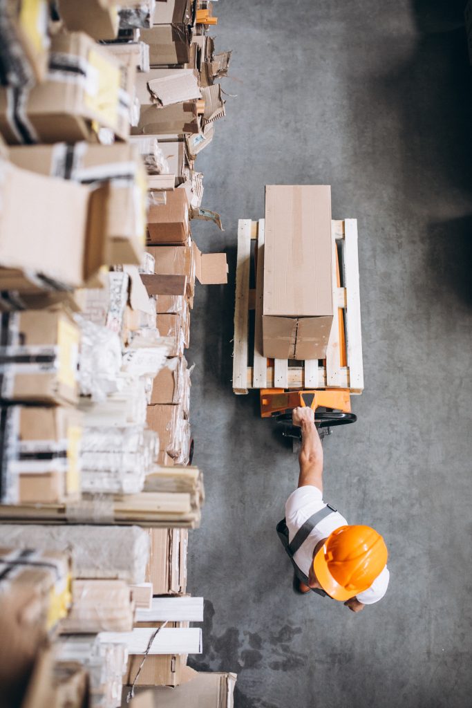 Young man working at a warehouse with boxes